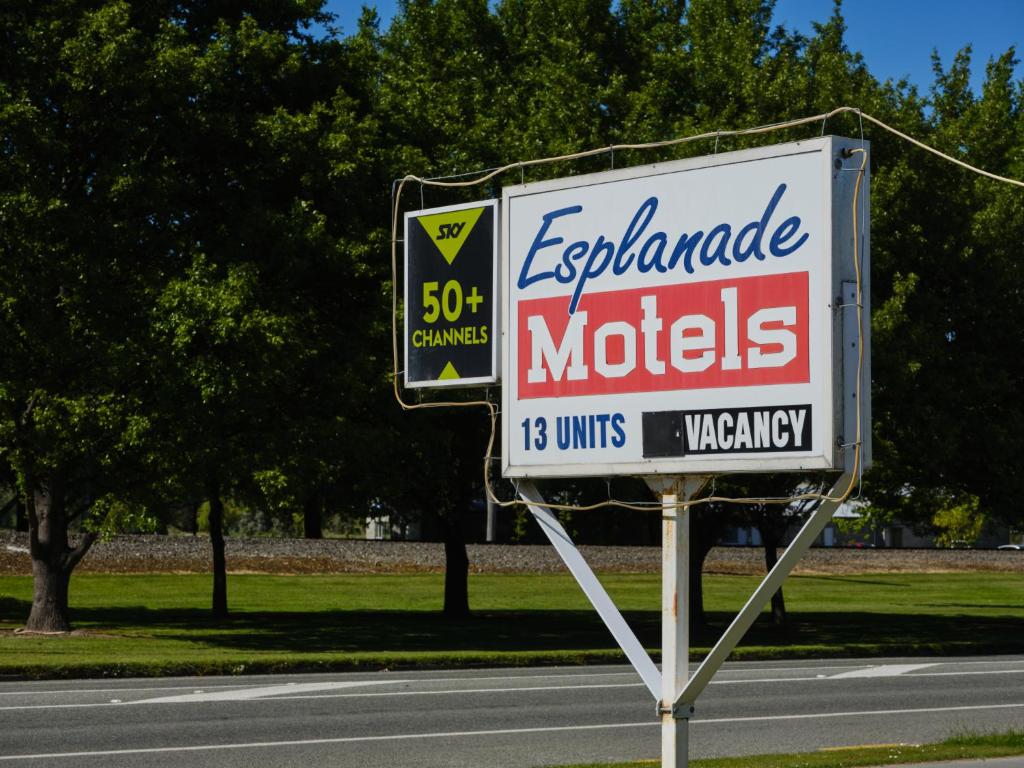 a sign for an exxon cartridge motel on the side of a road at Esplanade Motels in Gore