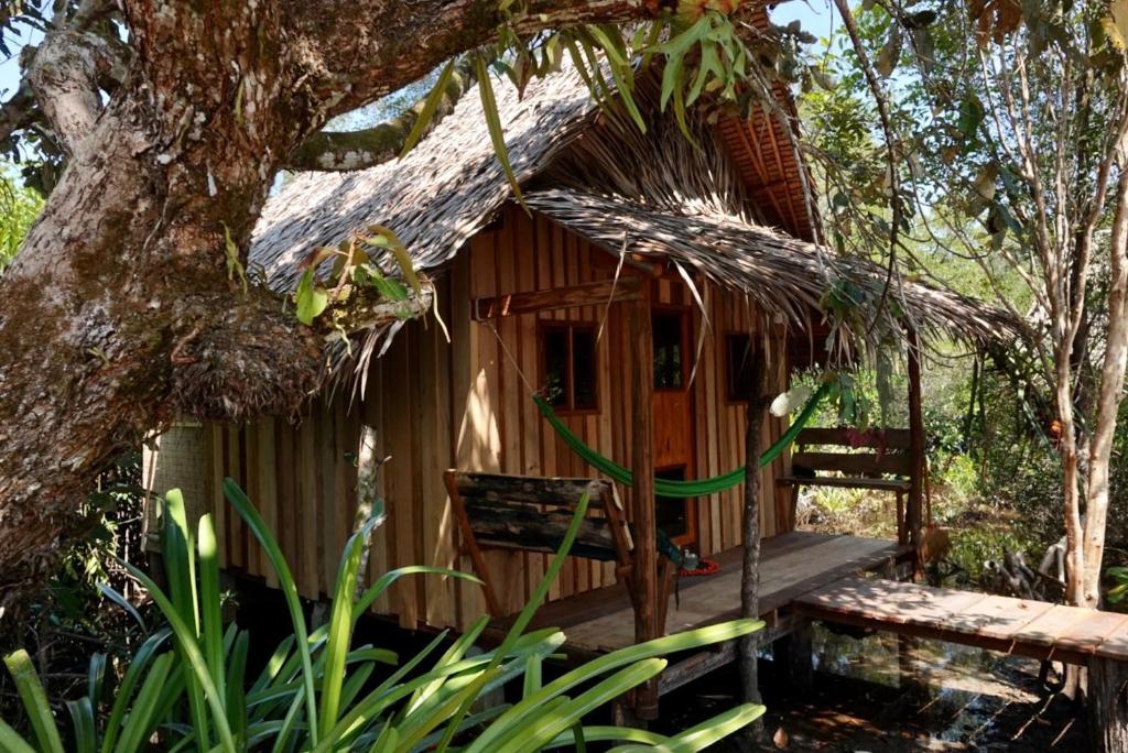 a tree house with a porch and a bench at Lily's Riverhouse in Koh Rong Island