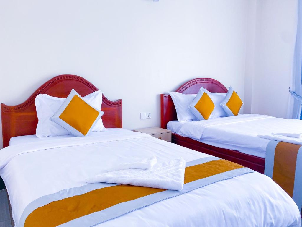 Postel nebo postele na pokoji v ubytování Sopheak Mongkol Guesthouse