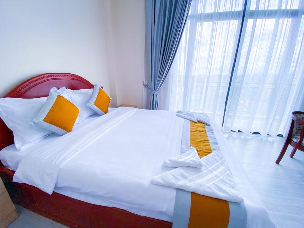 Postel nebo postele na pokoji v ubytování Sopheak Mongkol Guesthouse