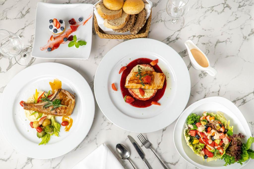 Overhead view of a multi-dish meal served on a marble-topped table.