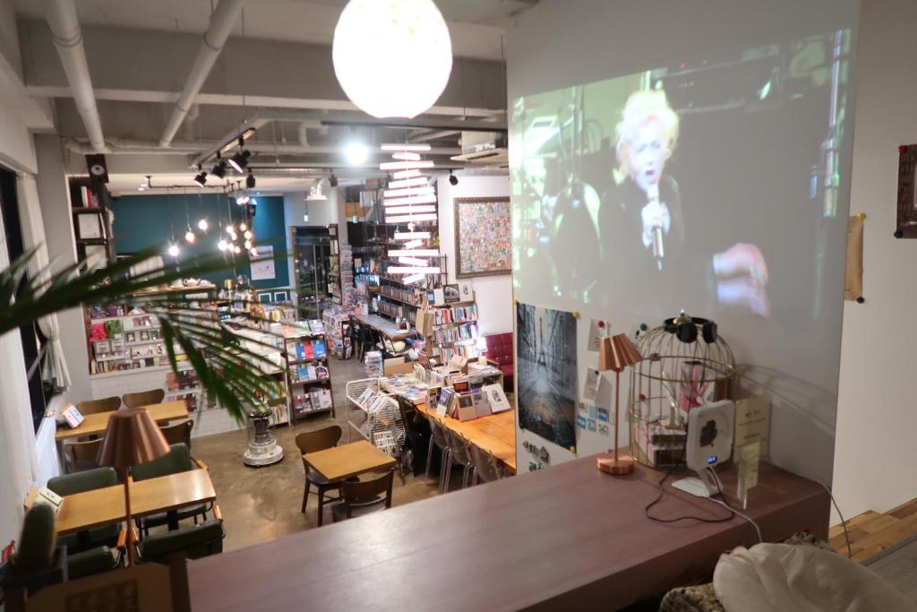 a room with a table and chairs in a store at Andong Poong-gyung HOSTEL n LIBRARY in Andong