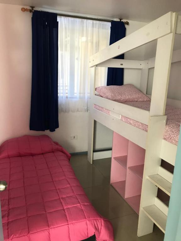a bedroom with two bunk beds and a bed at Departamento La Serena in La Serena