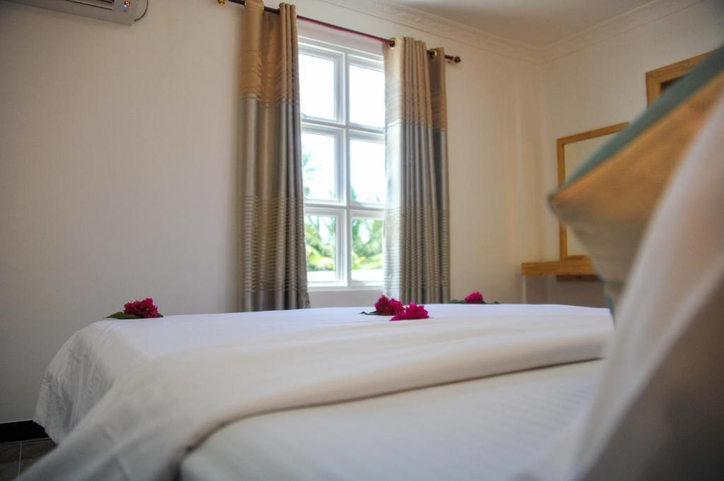 Postel nebo postele na pokoji v ubytování Asseyri Guest House