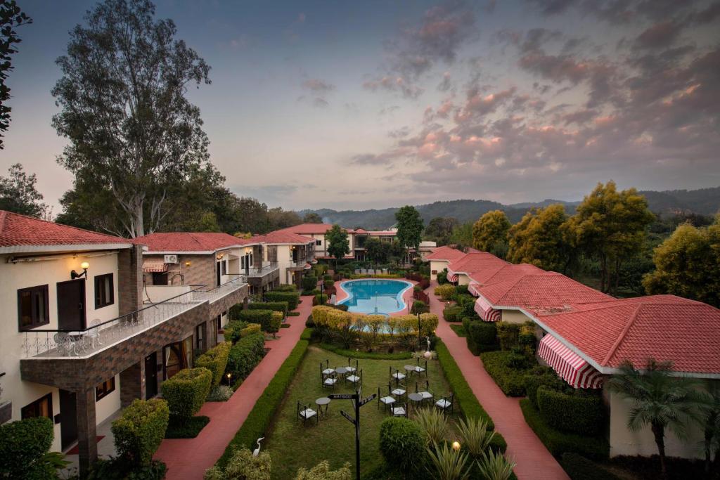 an aerial view of a resort with a swimming pool at Country Inn Tarika Riverside Resort Jim Corbett in Garjia