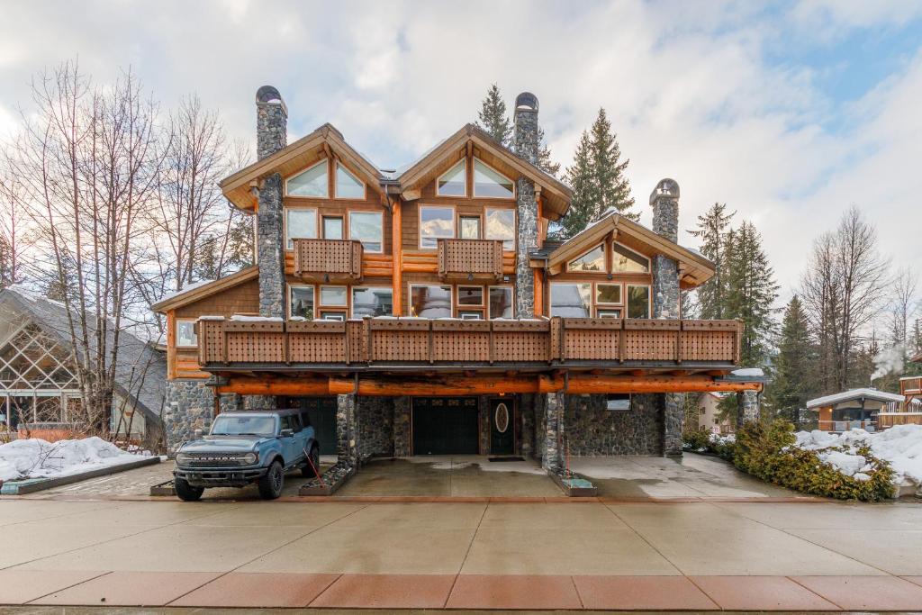 a large house with a balcony on top of it at Mountain Chalet in Girdwood