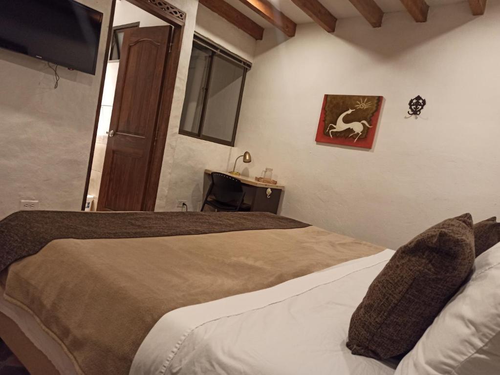 Postel nebo postele na pokoji v ubytování HOTEL LA POSADA DEL ZAGUÁN
