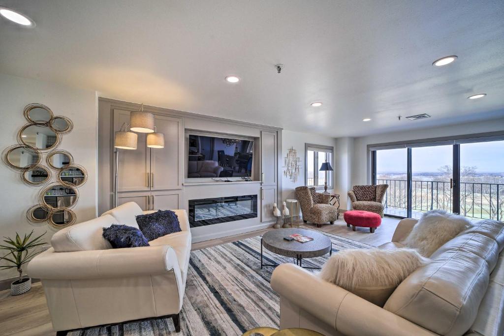 a living room with two couches and a fireplace at Balcony & Lake View: Modern Condo in Monkey Island in Monkey Island