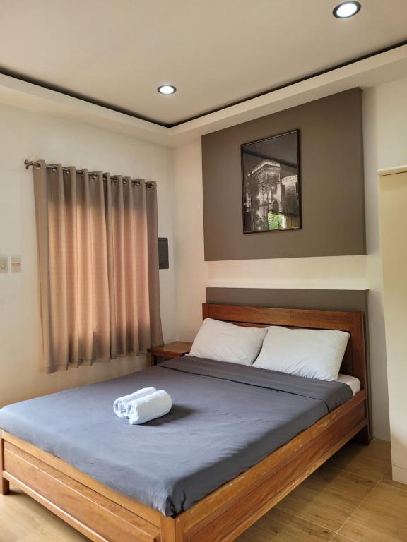 a bedroom with a large bed with at La Belle Staycation in Puerto Princesa City