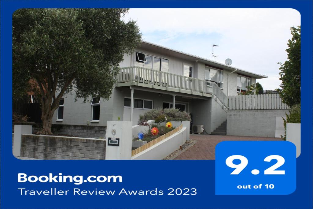 a picture of a house with the text travelling review awards at Glamis Ave Shared Home B&B in New Plymouth