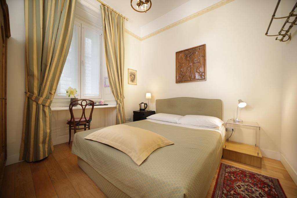 Postel nebo postele na pokoji v ubytování Residenza Le 6 A