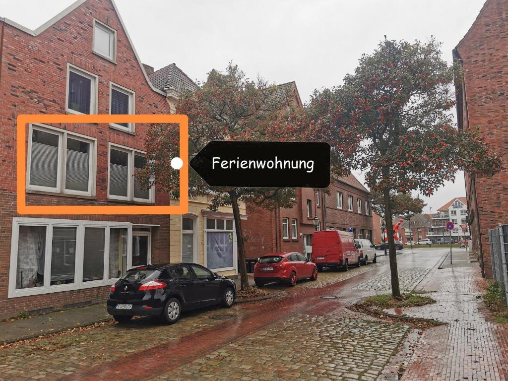 a sign on a street with a car parked on the street at Ferienwohnung Lüttje Delftblick in Emden
