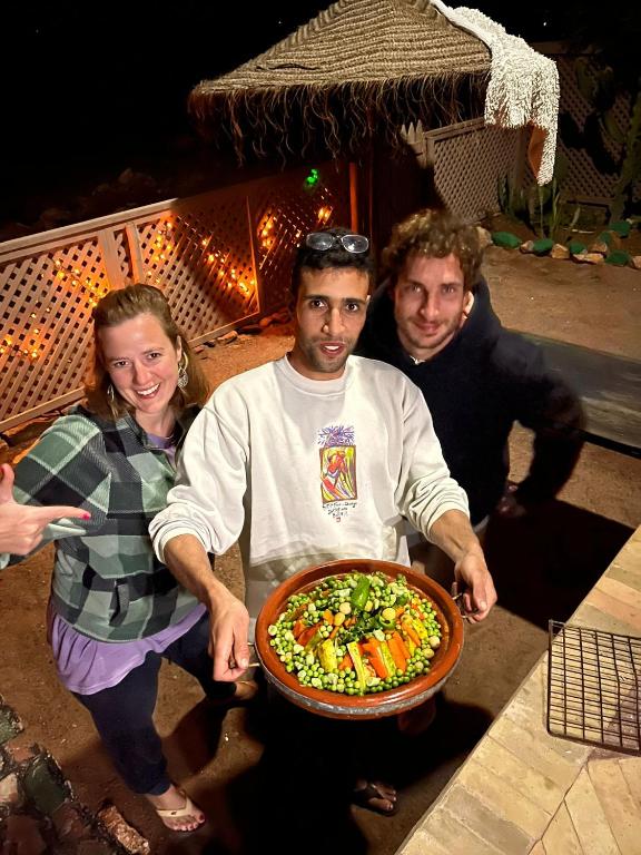 a group of people posing with a plate of food at Dar diafa samira in Mirleft
