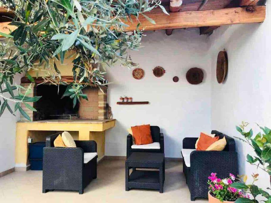 a living room with two chairs and a fireplace at Casa Magar Pula in Pula