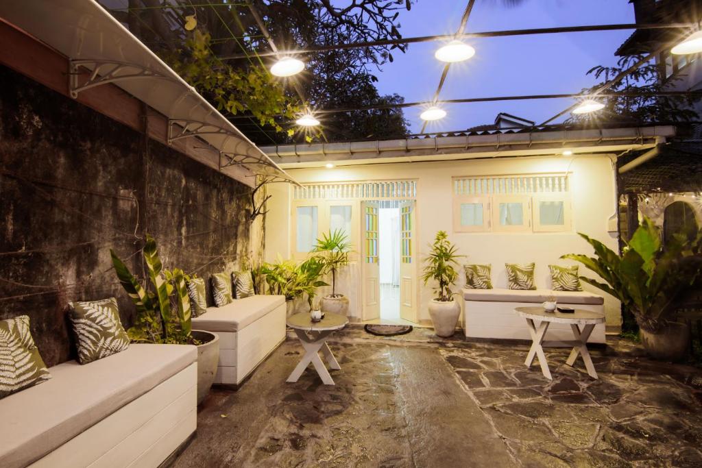 a patio with couches and a table and plants at BunkyDew in Galle
