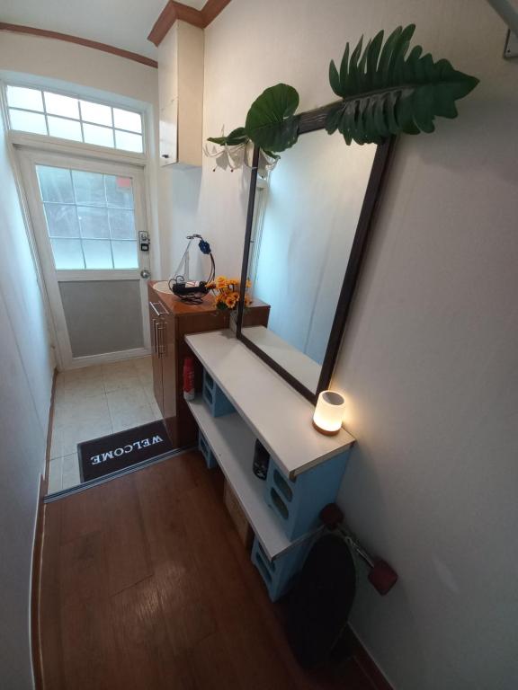 a mirror on the wall of a room with a table at Newly renovated hidden gem #2 in Seoul