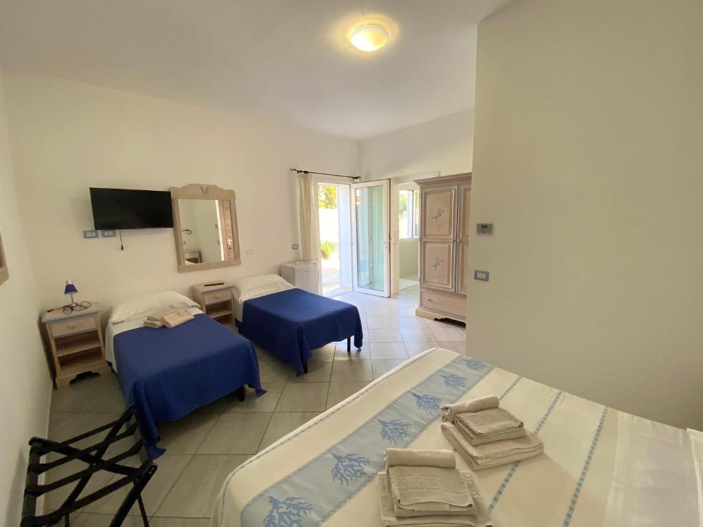 a hospital room with two beds and a television at Tigrillo Bed&Breakfast in Olbia