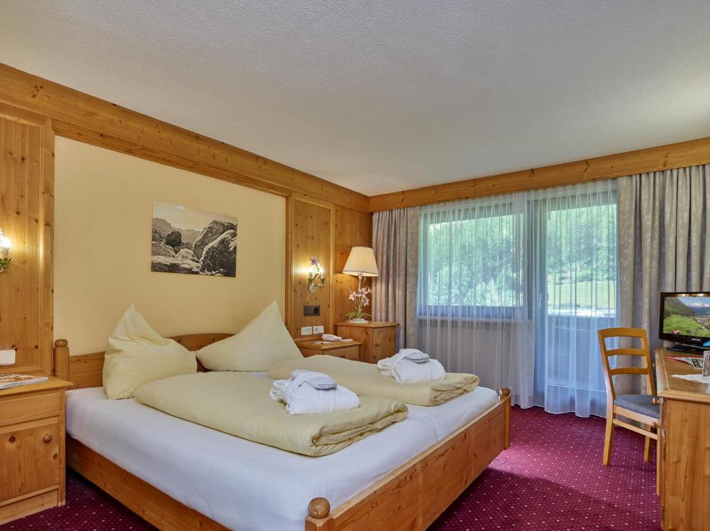 Postel nebo postele na pokoji v ubytování Hotel Erhart Sölden