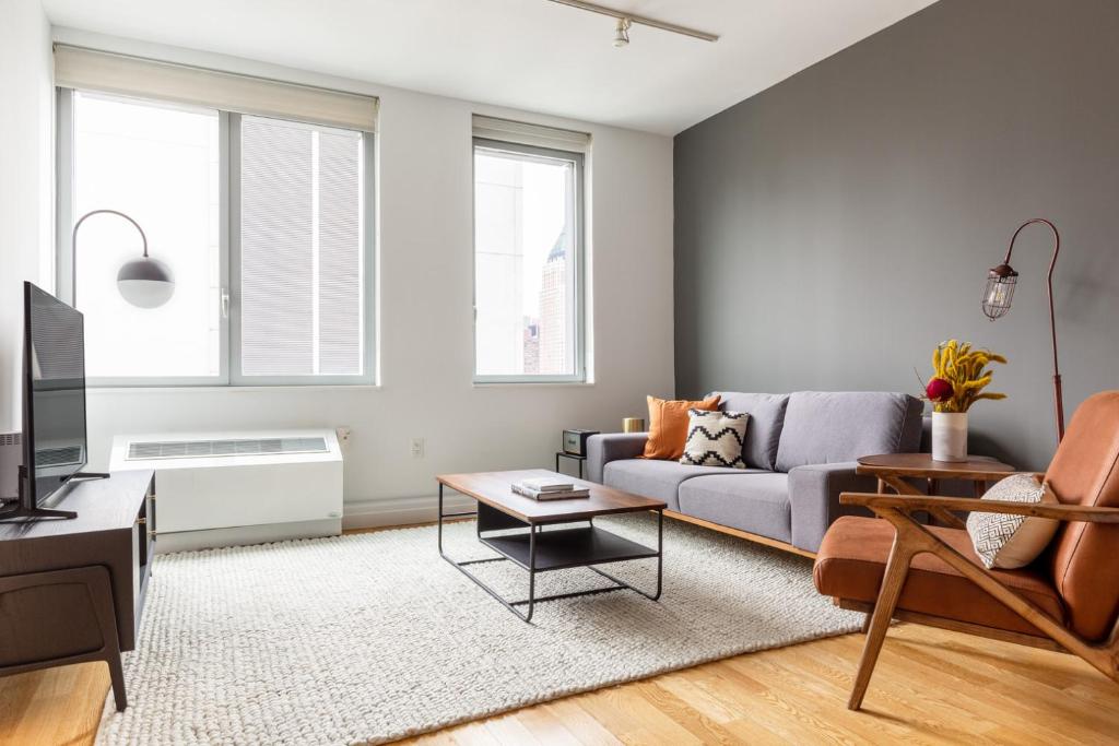 a living room with a couch and a table at Hells Kitchen 2BR w Pool DM nr Central Park NYC-469 in New York