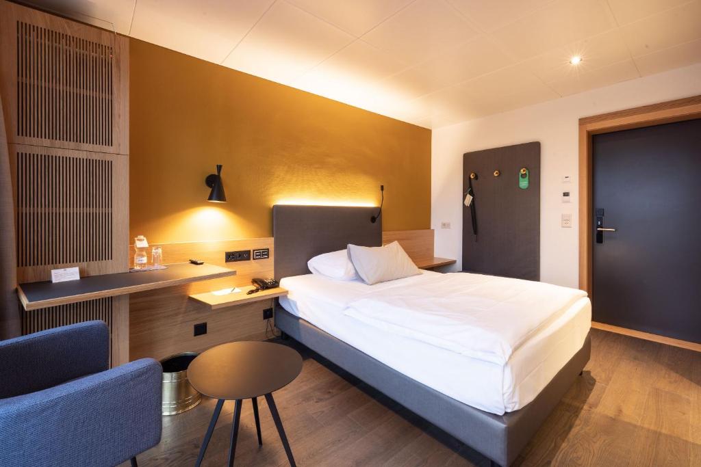 Postel nebo postele na pokoji v ubytování Engimatt City & Garden Hotel