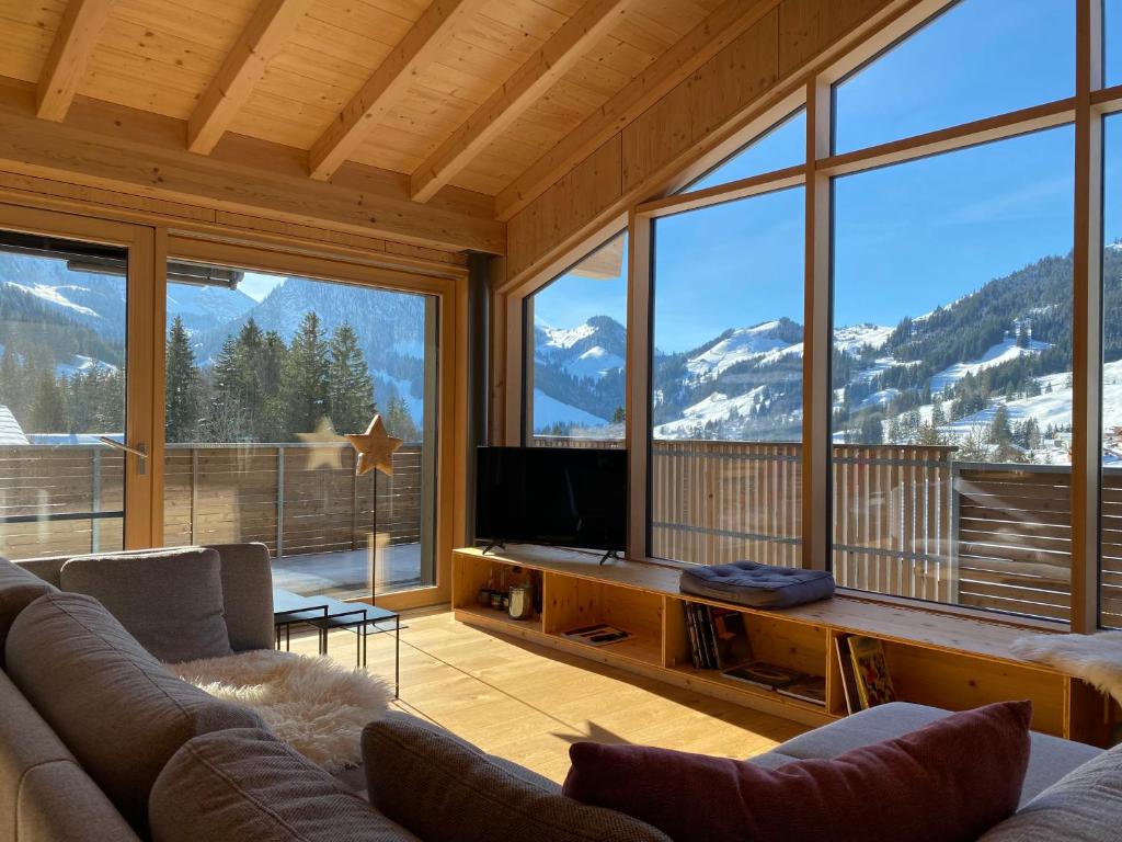 a living room with a couch and a large window at Horizon 4 in Schwarzsee