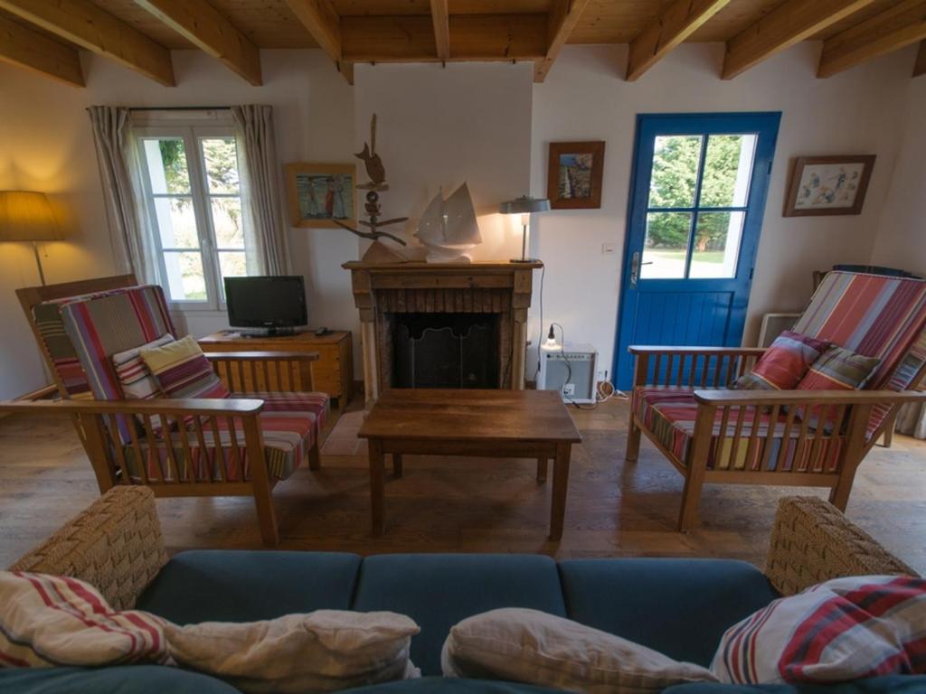 a living room with a couch and a fireplace at Maison Locmaria, 6 pièces, 10 personnes - FR-1-418-5 in Locmaria