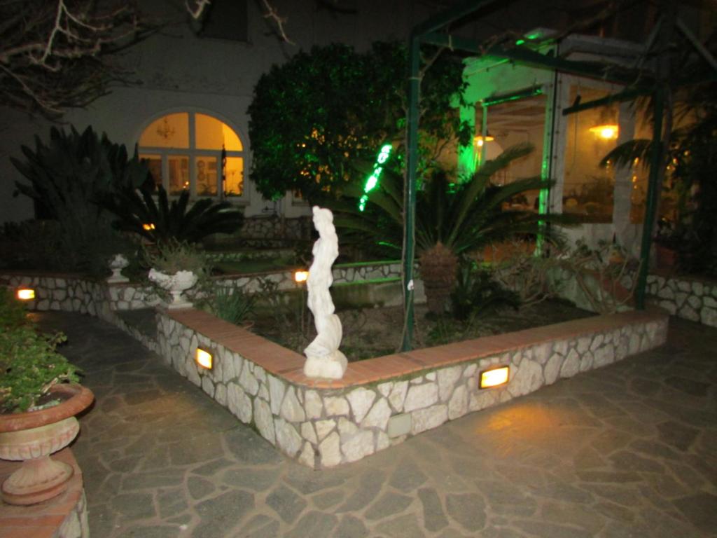 a fountain in the middle of a courtyard at night at B&B Palazzo a Mare in Capri