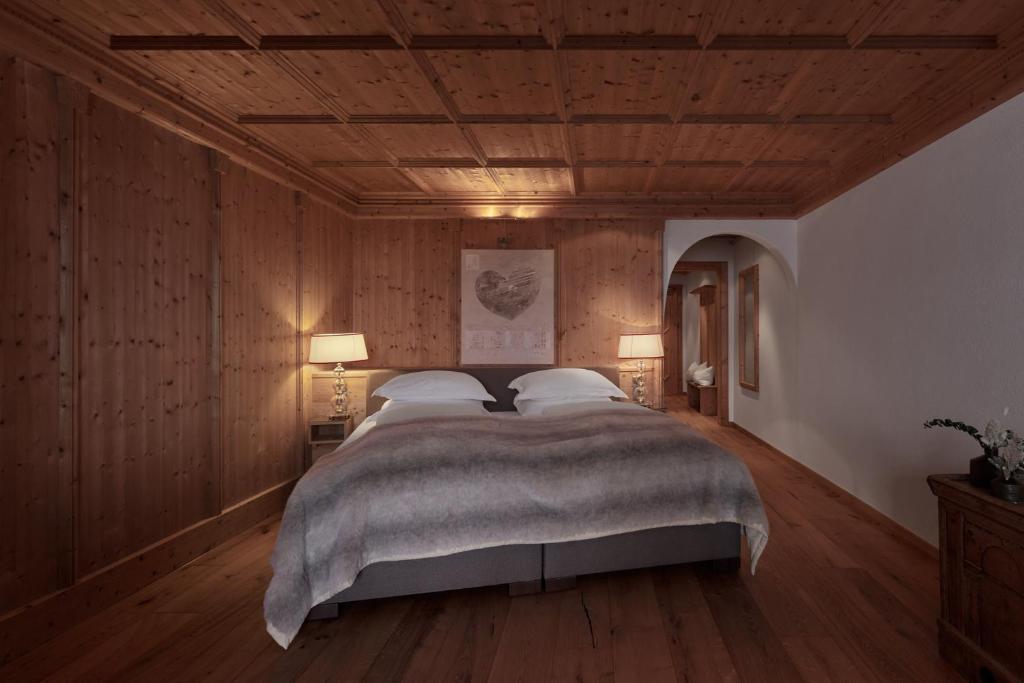 a bedroom with a large bed with wooden walls at TOP Hotel Hochgurgl in Hochgurgl
