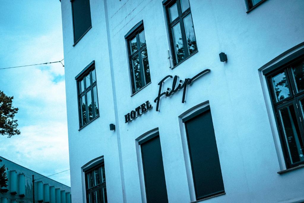 a white building with a hooters fire sign on it at Hotel Filip in Oslo