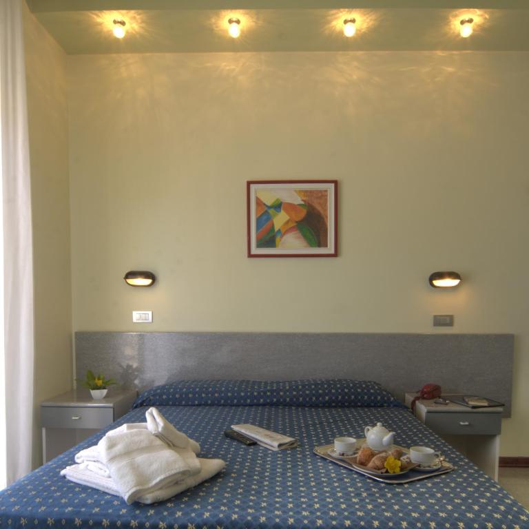 Postel nebo postele na pokoji v ubytování Hotel Reggiana