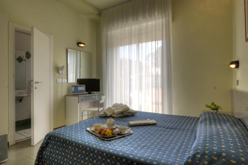 Postel nebo postele na pokoji v ubytování Hotel Reggiana