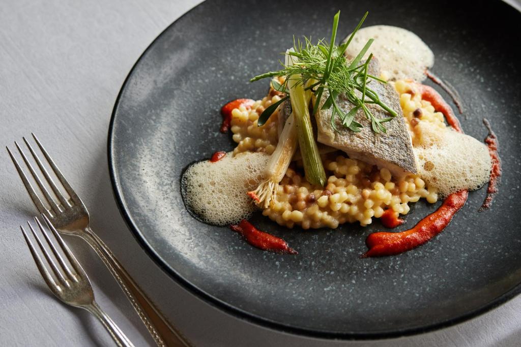 a plate of food with corn and vegetables on a table at TOP Hotel Hochgurgl in Hochgurgl