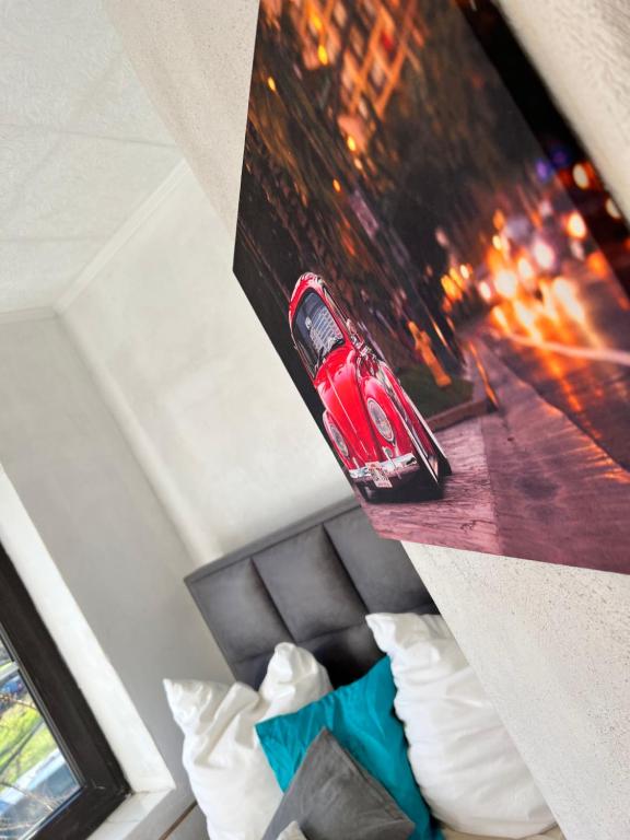 a picture of a red car on top of a bed at Geroweiher Monteurzimmer Mönchengladbach Stadtmitte in Mönchengladbach