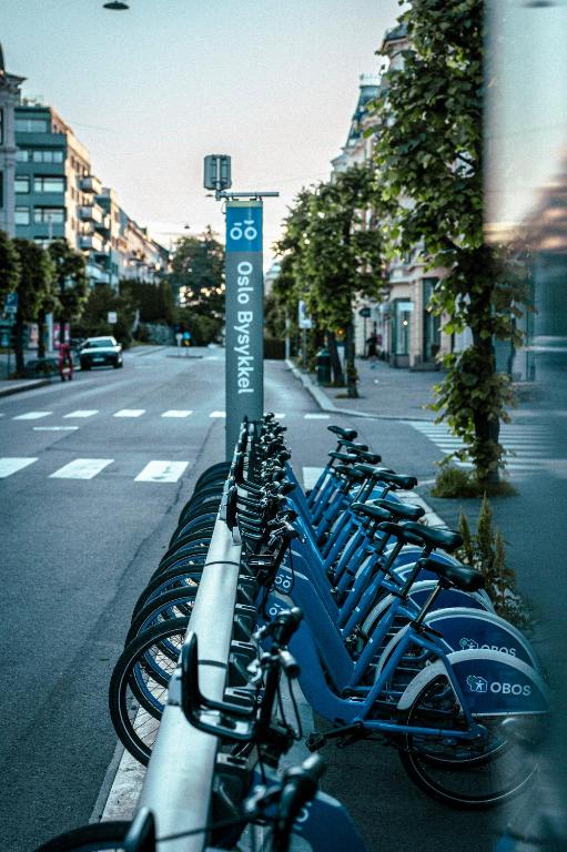 a row of bikes parked on the side of a street at Hotel Filip in Oslo
