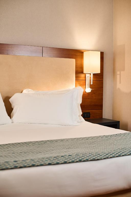Postel nebo postele na pokoji v ubytování Hotel Da Vinci