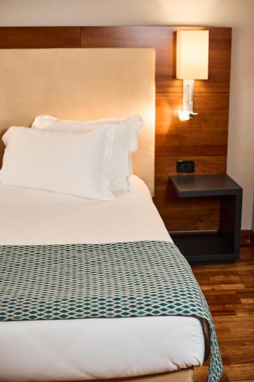 Postel nebo postele na pokoji v ubytování Hotel Da Vinci