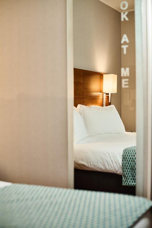 Postel nebo postele na pokoji v ubytování Hotel Da Vinci