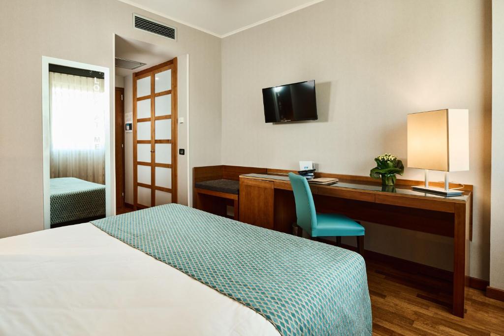 Postel nebo postele na pokoji v ubytování Hotel Da Vinci