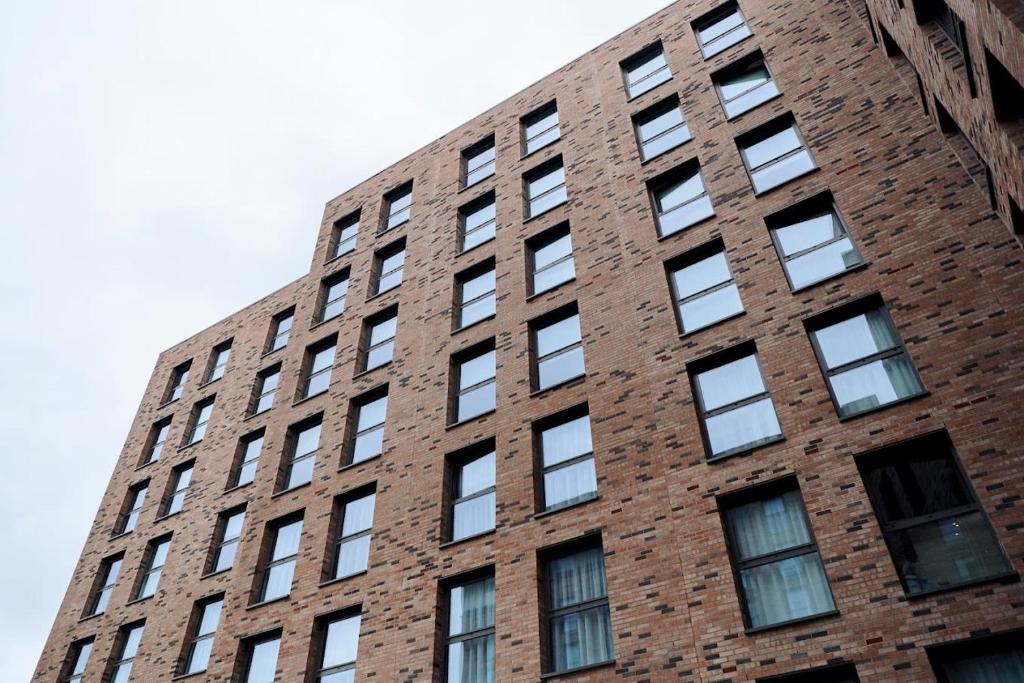 a tall brick building with lots of windows at Private Bedrooms with Shared Kitchen, Studios and Apartments at Canvas Glasgow near the City Centre for Students Only in Glasgow