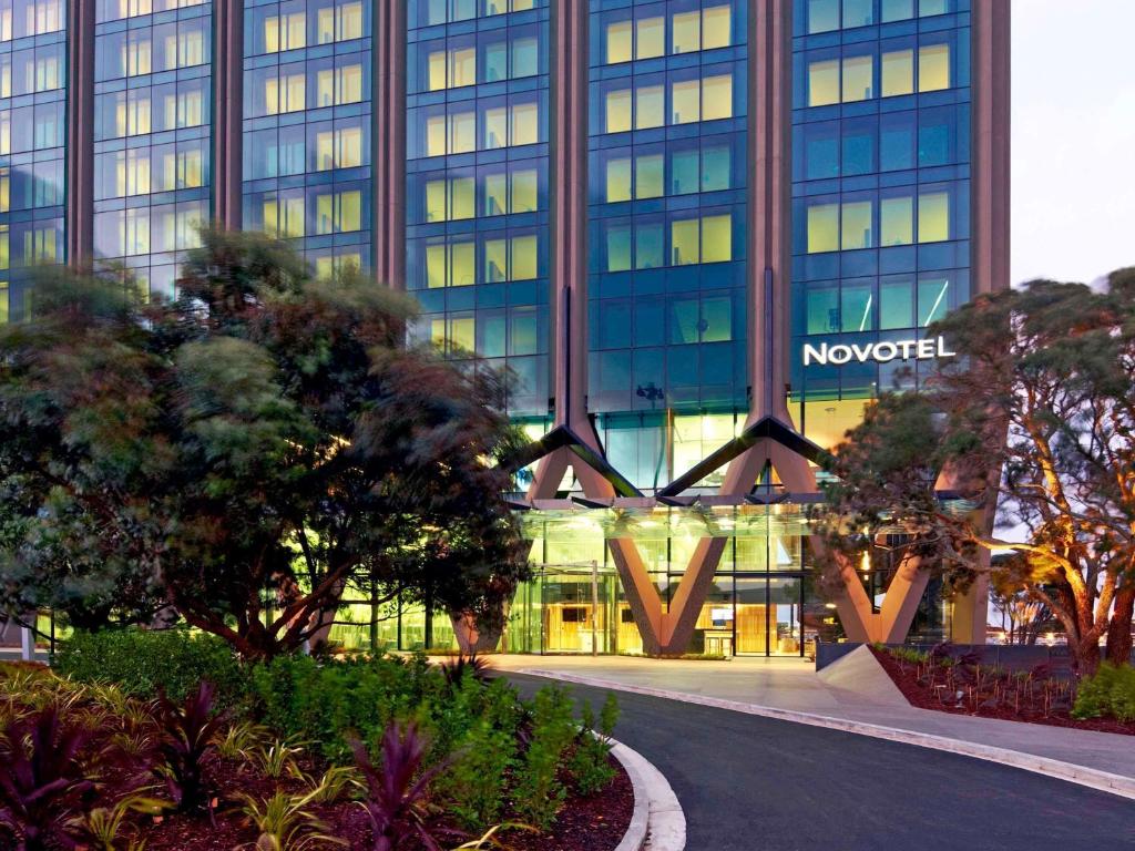 a building with a sign on the front of it at Novotel Auckland Airport in Auckland