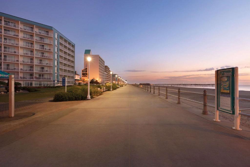 a street with lights on the side of a beach at Surfbreak Virginia Beach Oceanfront, Ascend Hotel Collection in Virginia Beach