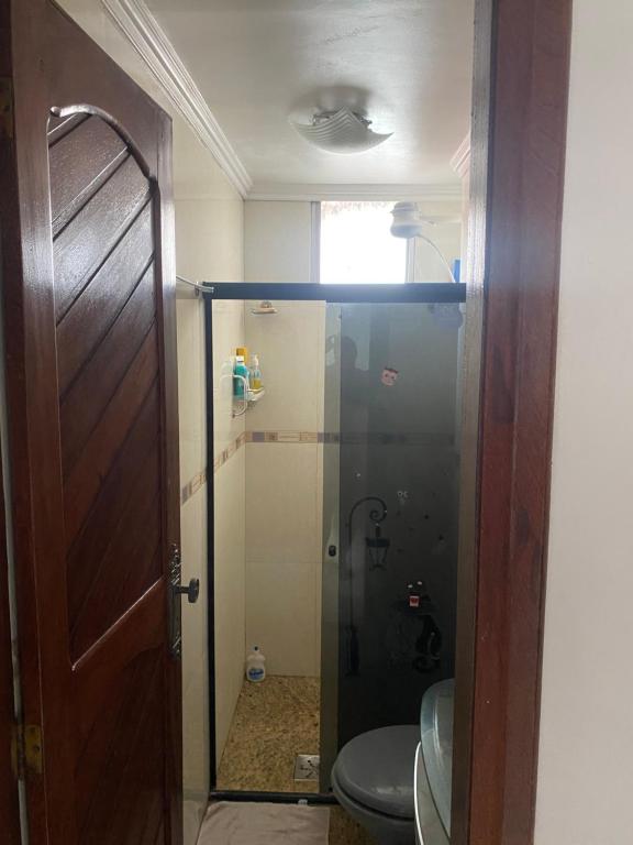 uma casa de banho com um chuveiro, um WC e uma porta em Apto na Avenida Marques de Herval em Belém