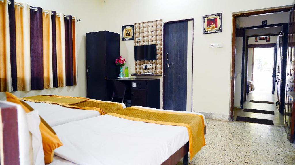 Postel nebo postele na pokoji v ubytování Rampriya Service Apartment