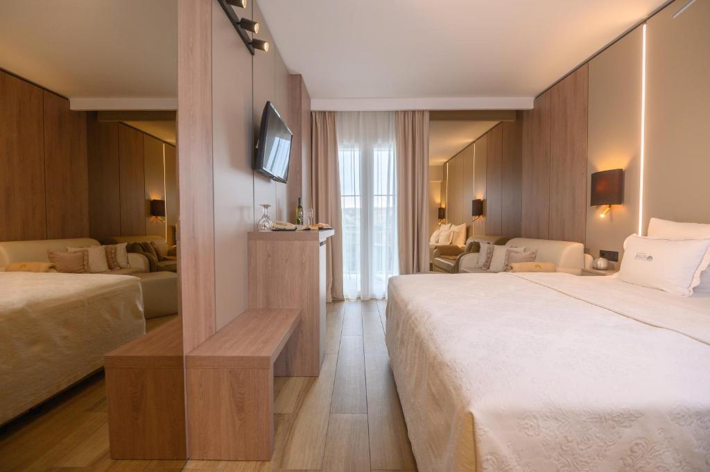 Postel nebo postele na pokoji v ubytování Hotel Malin