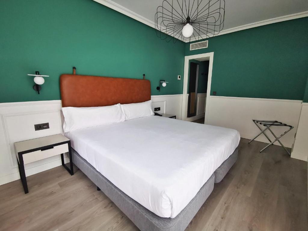Postel nebo postele na pokoji v ubytování Hotel Don Rodrigo