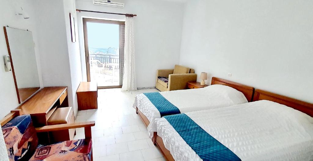 Postel nebo postele na pokoji v ubytování Hotel Pashos