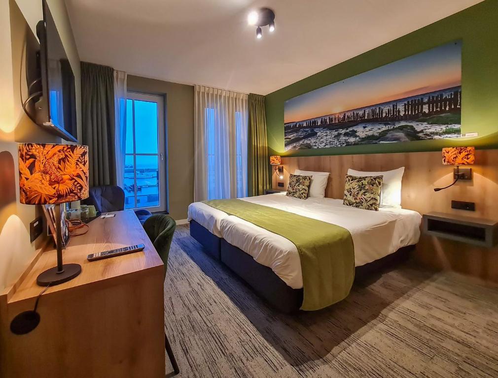 een hotelkamer met een bed en een bureau bij Schierzicht Logement in Lauwersoog