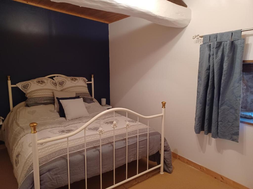 a bedroom with a white bed in a room at Wisteria Cottage at Gites de la Vienne in Chaunay