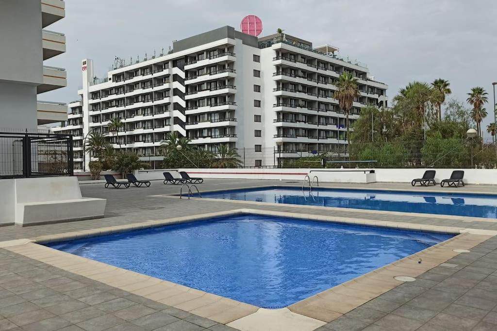 una piscina di fronte a un grande edificio di Altemar in las Américas ad Arona