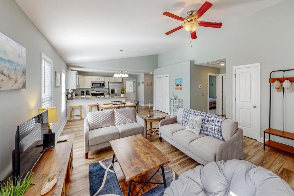 a living room with a couch and a table at Oak Island Oasis in Oak Island